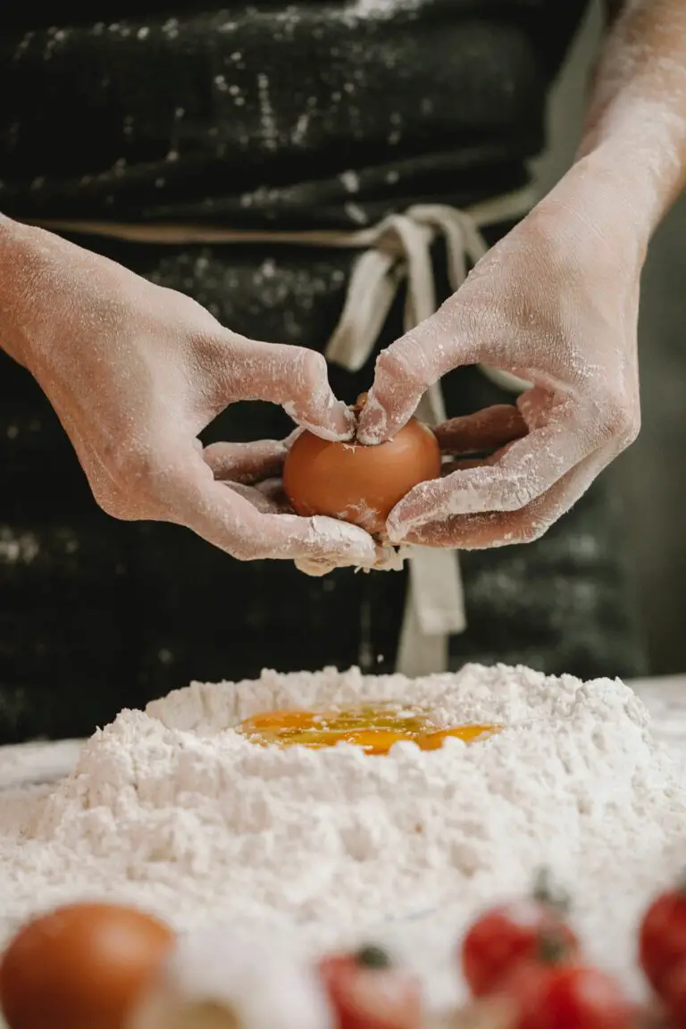 Are Sedums Edible - Crop cook breaking egg into flour