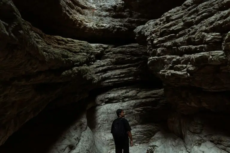 Sedimentary rocks formation depicted by a man exploring a cave