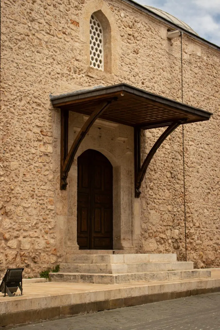 Sedum roof on a stone building with a wooden door enhancing the aesthetic appeal in urban architecture