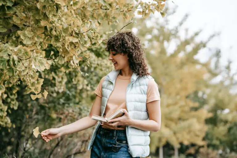 where to plant sedum autumn joy, with a happy young female in casual clothes in an autumn park