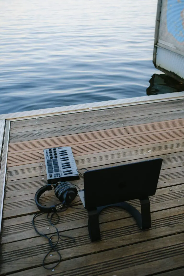 will sedum root in water with a laptop and keyboard on a dock